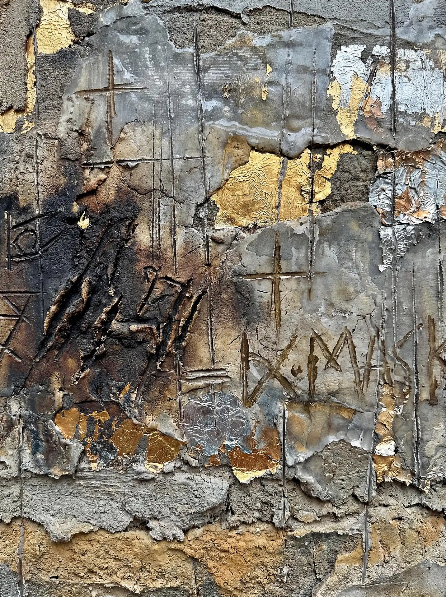 Muted gray and metallic gold tones define this textured concrete artwork featuring charred surfaces and etched symbols. This weathered industrial piece combines raw construction materials with delicate metallic leaf for a complex, urban aesthetic. Artwork by Constantine Cheshire