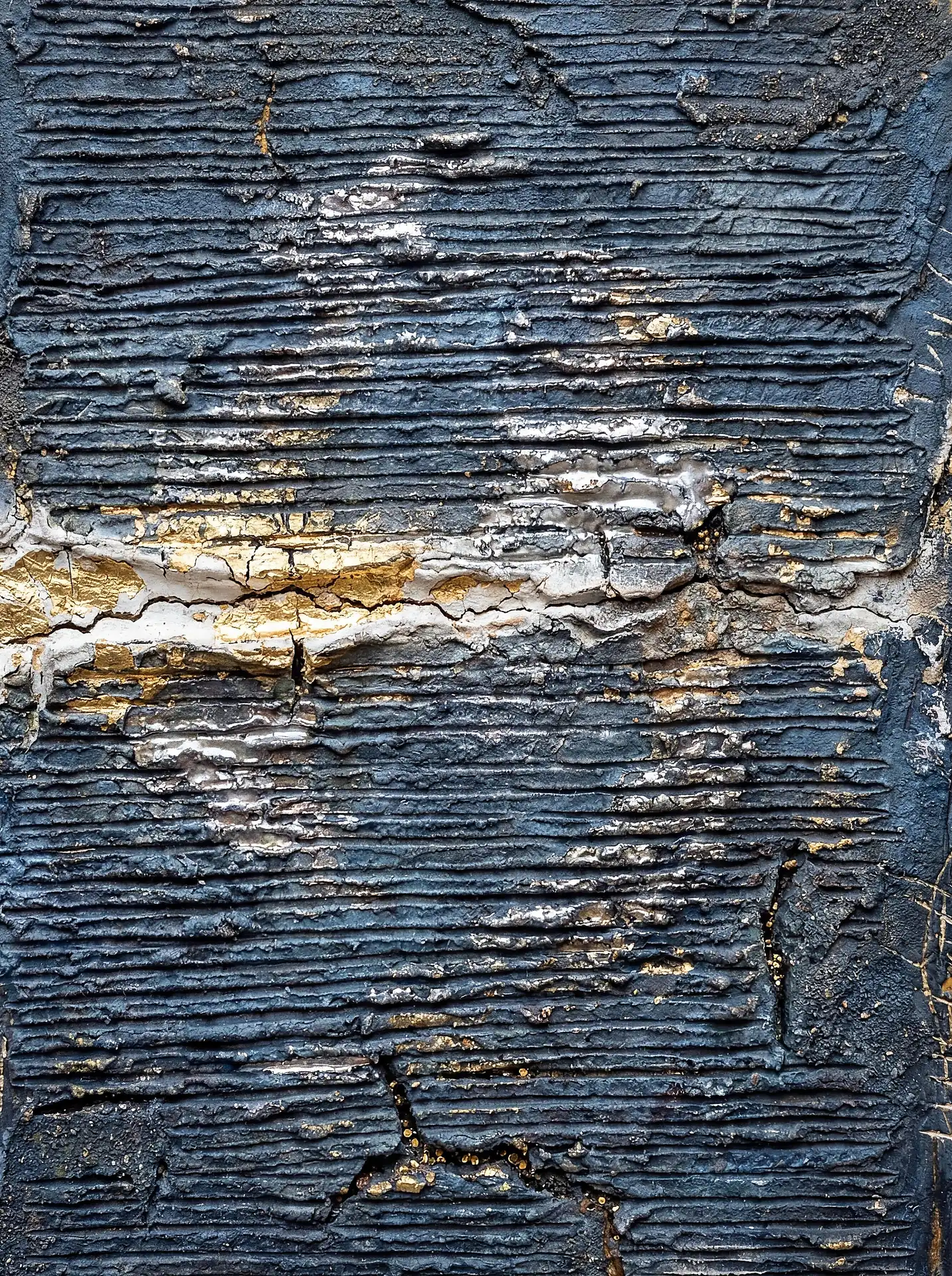 Textured abstract wall art created with heavy impasto ridges and metallic gold leaf over a deep navy blue background. This mixed media piece showcases a weathered, industrial style with intricate cracks and a tactile, three-dimensional surface. Artwork by Constantine Cheshire