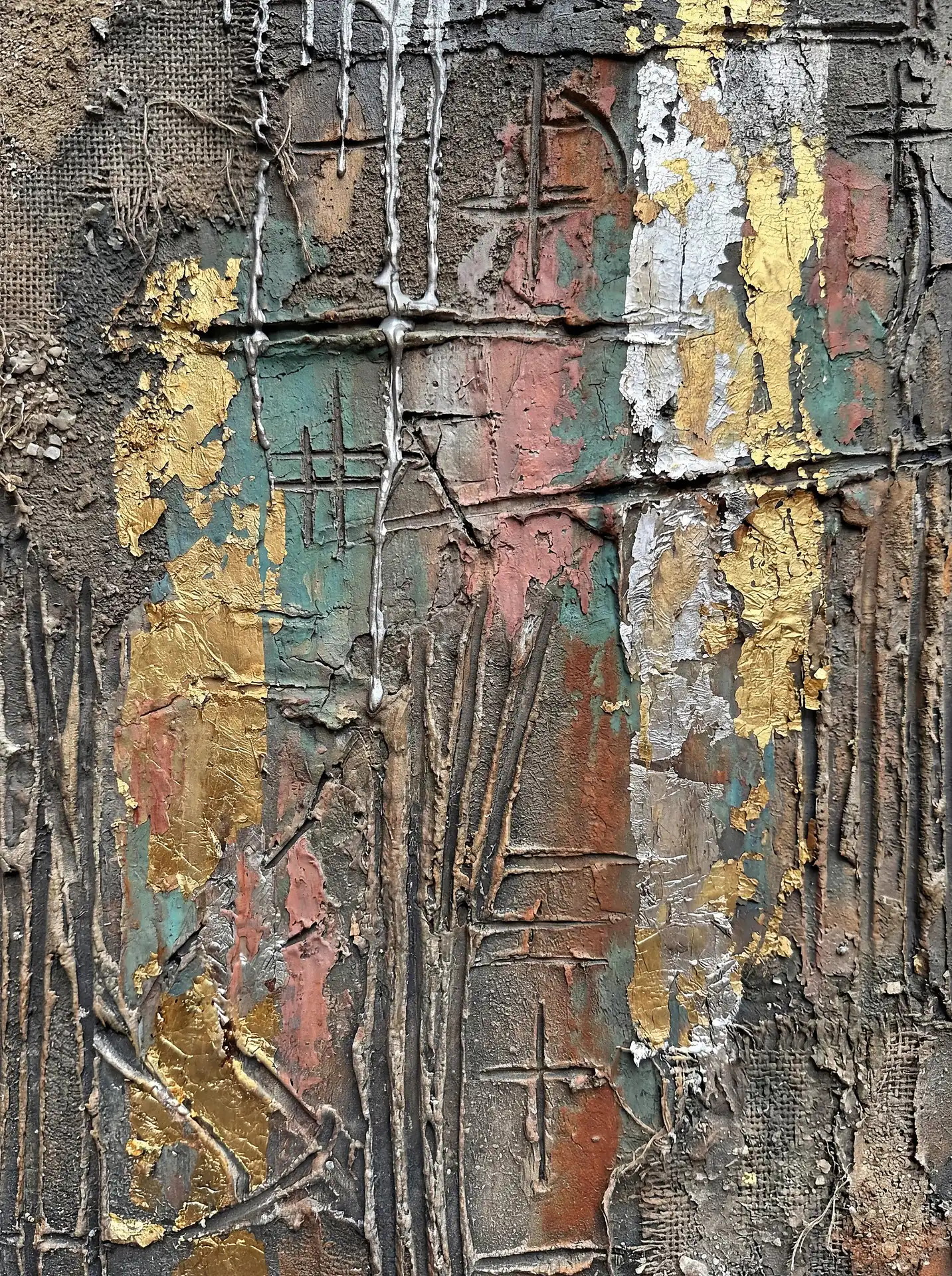 Layering of metallic gold leaf and silver drips over a grimy, textured surface creates a sense of industrial decay and luxury. This abstract piece features a complex arrangement of burlap mesh, carved symbols, and muted teal and terracotta tones for a gritty, contemporary mood. Artwork by Constantine Cheshire