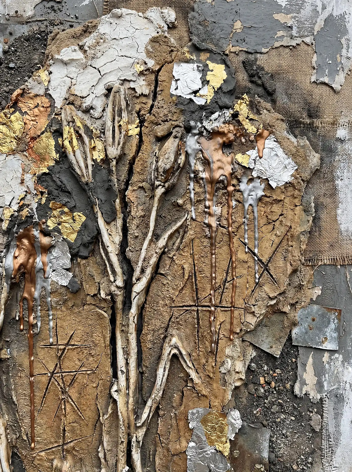 Somber and industrial, this sculptural relief features 3D flower buds emerging from cracked earth tones and metallic silver drips. The composition blends raw burlap and distressed plaster with delicate gold leaf for a striking tactile contrast. Artwork by Constantine Cheshire