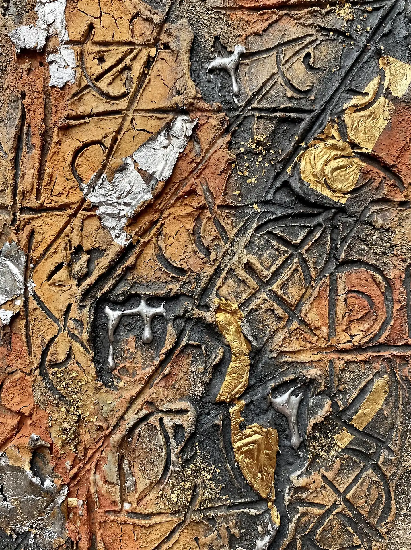 Heavily textured mixed media artwork featuring carved symbols and earthen tones of terracotta and charcoal. Accents of molten silver and gold leaf create a sense of ancient discovery and industrial decay across the relief surface. Artwork by Constantine Cheshire