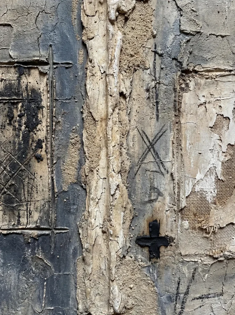 Tearing through heavy layers of plaster, this mixed media artwork reveals raw burlap and charcoal markings. The industrial composition utilizes neutral tones of grey, beige, and black to create a gritty, tactile atmosphere suitable for contemporary design. Artwork by Constantine Cheshire