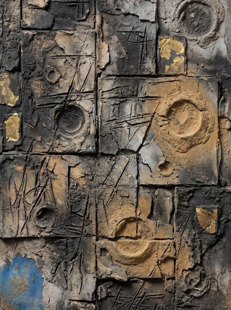 Deep shadows and golden highlights accentuate this abstract mixed-media relief sculpture made of cracked clay tiles. The brutalist piece features incised lines, circular imprints, and weathered earthy tones of charcoal and ochre. Artwork by Constantine Cheshire