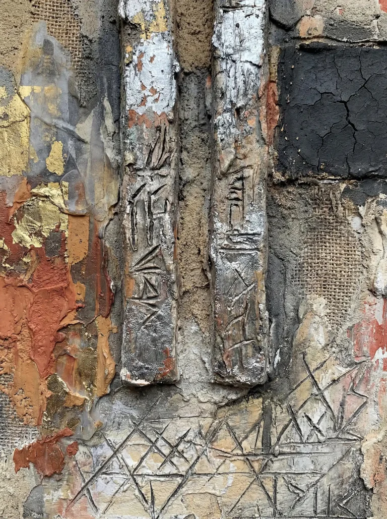 An ancient and mysterious atmosphere is evoked by two carved silver pillars set against a backdrop of cracked black stone, gold leaf, and woven burlap. This contemporary mixed media piece explores tactile surfaces through a blend of earthy terracotta tones and weathered industrial materials. Artwork by Constantine Cheshire