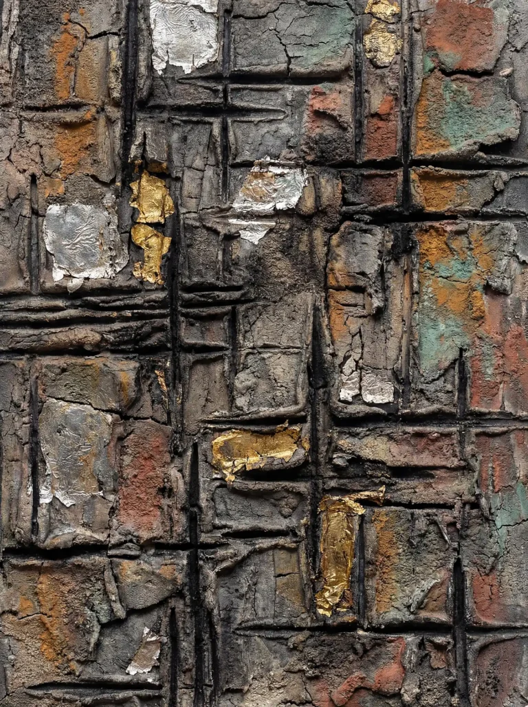 Muted earthy tones and metallic highlights define this abstract relief sculpture featuring a deeply textured, cracked surface. The industrial composition combines charcoal grey plaster with fragments of gold and silver leaf for a weathered, wabi-sabi aesthetic. Artwork by Constantine Cheshire