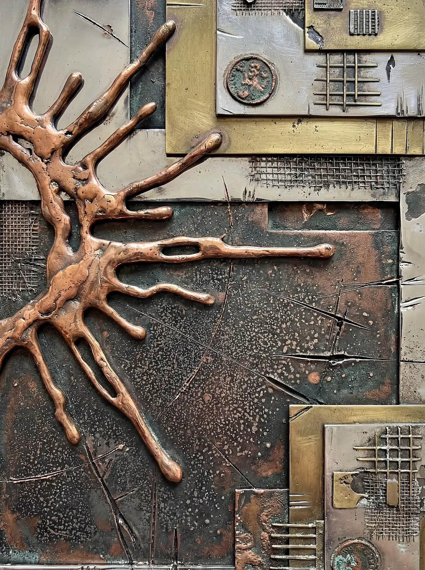 Abstract metal relief sculpture featuring weathered copper, brass plates, and industrial mesh textures. This contemporary mixed media piece highlights a central organic splash form contrasted against rigid geometric panels in a rich, aged metallic color palette. Artwork by Constantine Cheshire