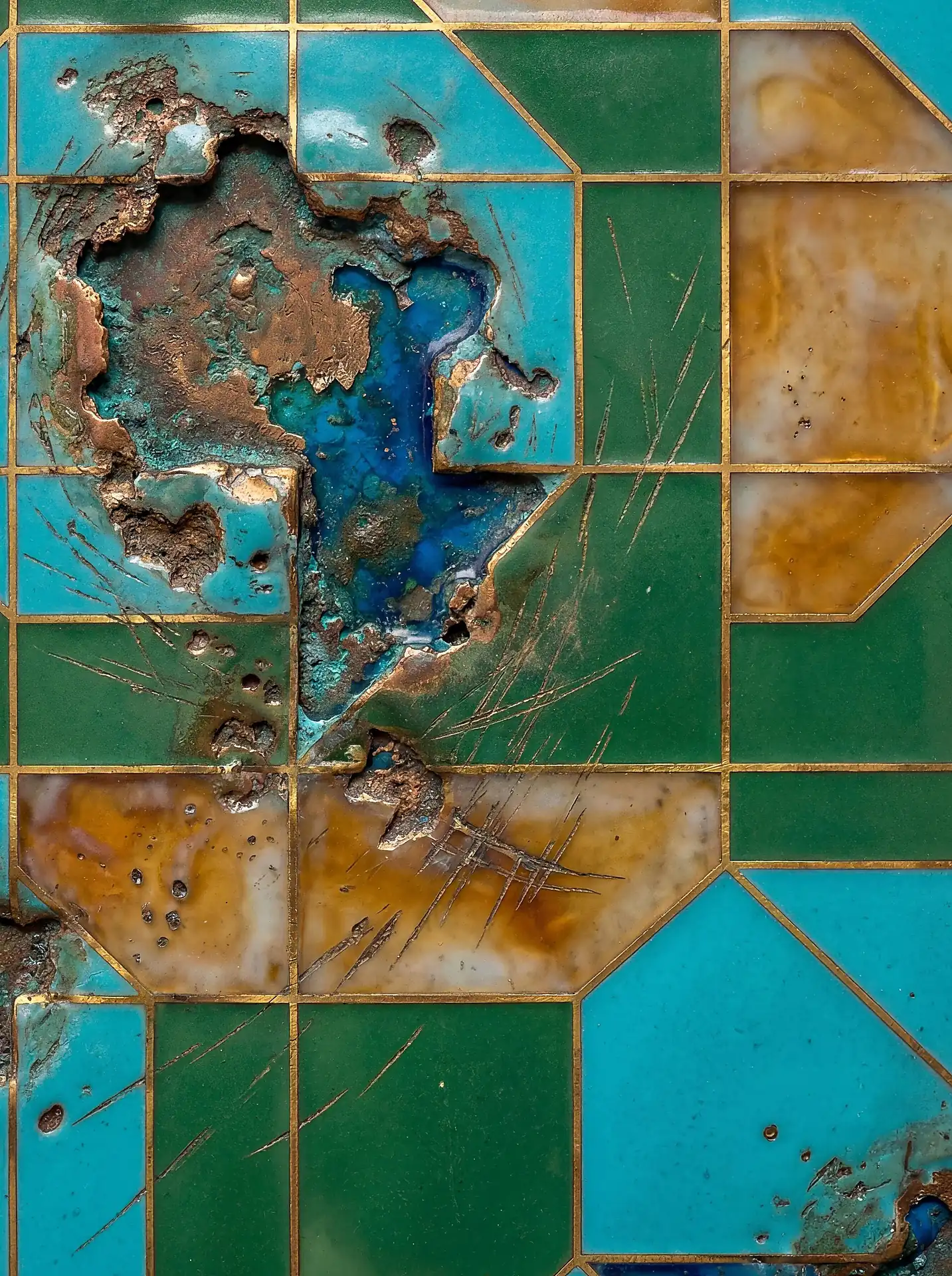 Bursting through the polished surface, a jagged crater reveals the oxidized copper heart of this geometric turquoise and green enamel inlay. This abstract composition blends the precision of gold-lined grids with the raw, textured decay of weathered metal and industrial patina. Artwork by Constantine Cheshire