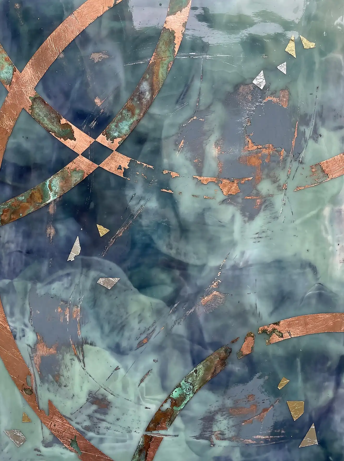 Copper leaf arcs and silver fragments accent this mixed media encaustic painting featuring translucent layers of teal, blue, and sage green wax. The contemporary composition blends metallic geometric shapes with organic, smoky textures to create a sophisticated and moody atmosphere. Artwork by Constantine Cheshire