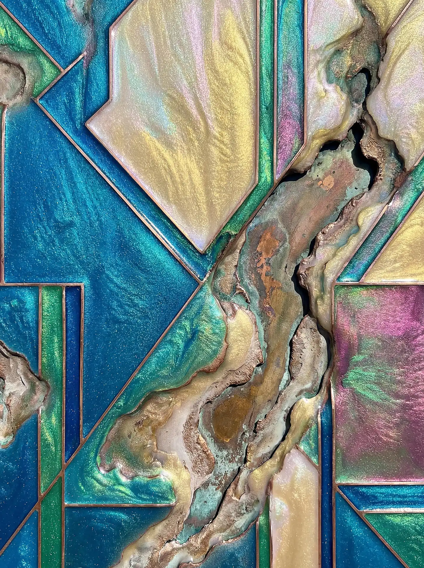 Iridescent resin and textured metallic pigments flow between sharp copper lines, centering on a jagged geological fissure. This mixed media composition blends architectural geometry with the organic movement of pearlescent teal, gold, and pink hues. Artwork by Constantine Cheshire