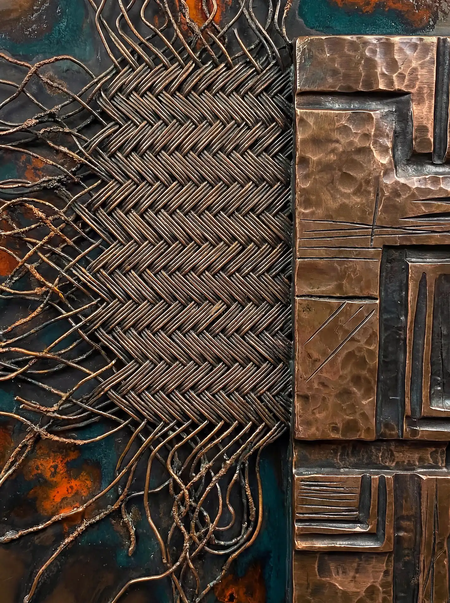 Deep teal and burnt orange oxidation highlights this intricate copper wire weave set against hammered bronze plates. This industrial mixed media piece combines tight herringbone textures with raw, unraveled metal strands for a complex, rustic aesthetic. Artwork by Constantine Cheshire