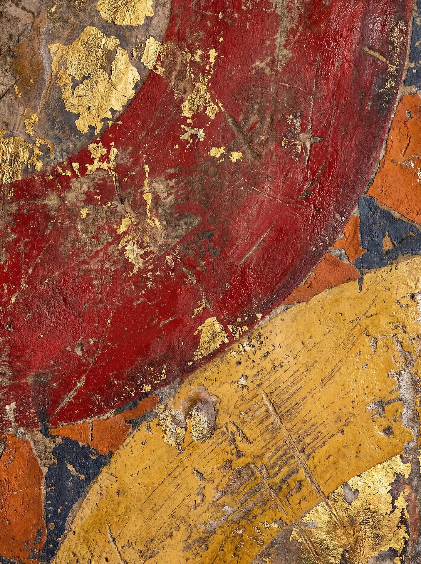 Ancient and weathered, this close-up captures layers of vibrant red and yellow pigments accented with real gold leaf flakes. The tactile surface reveals cracks and scratches from centuries of history on a traditional religious fresco or icon. Artwork by Constantine Cheshire