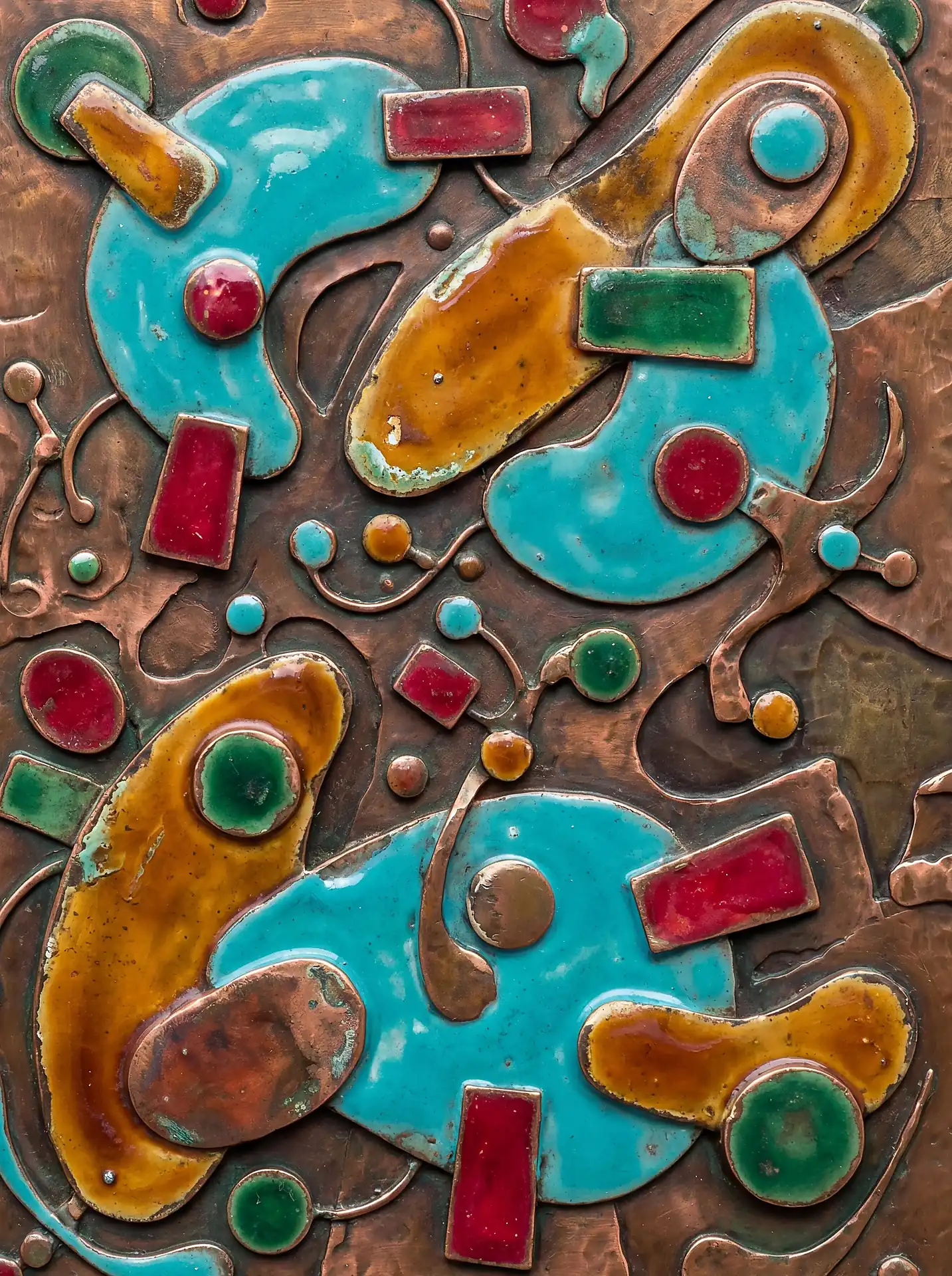Vibrant turquoise and amber enamel shapes catch the light against a hand-hammered copper relief. This mid-century modern abstract composition uses organic forms and geometric accents to create a rich, tactile surface full of depth. Artwork by Constantine Cheshire