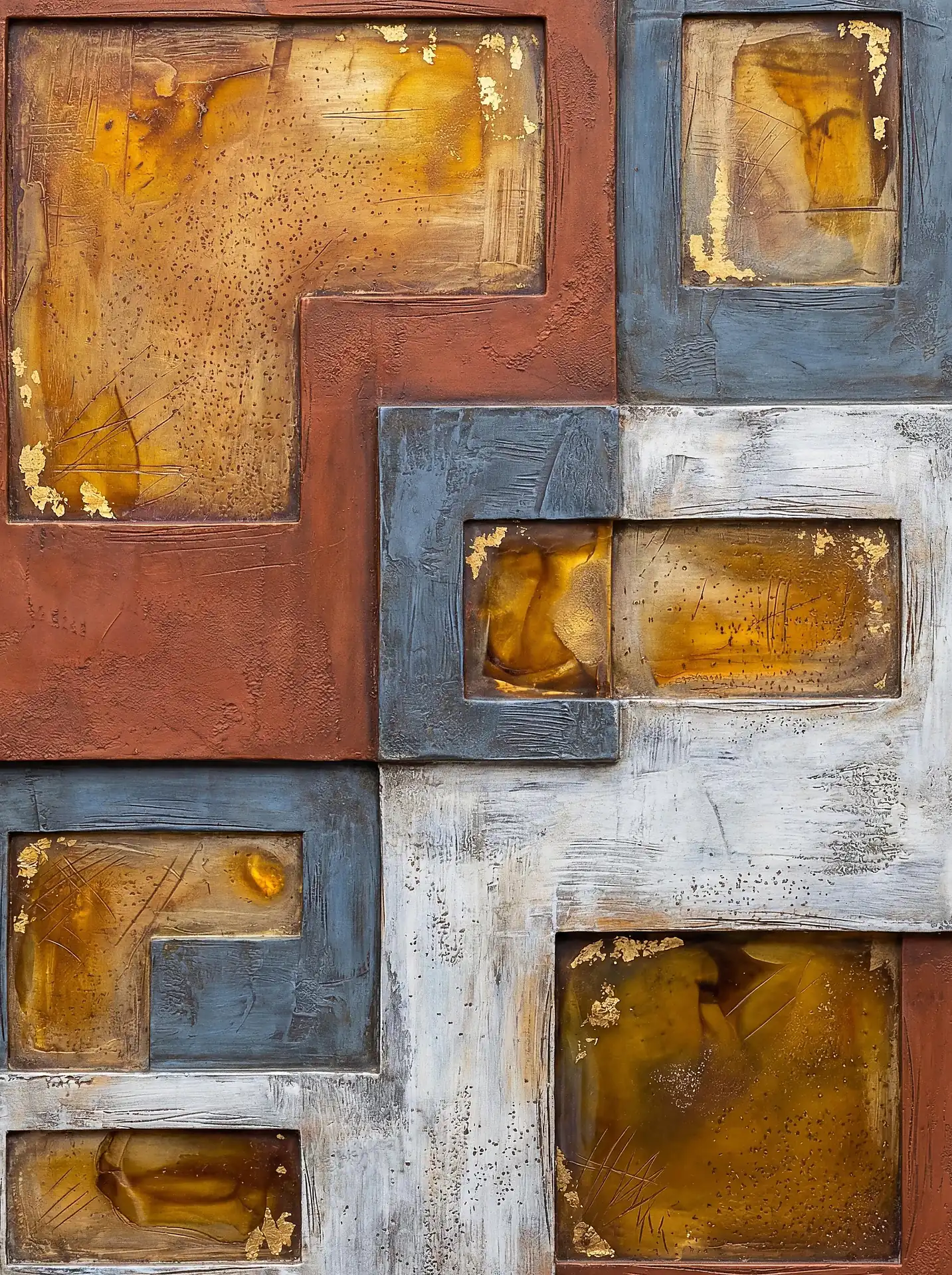 Golden light glows through amber resin inserts in this multi-textured geometric mixed media composition. The piece features a sophisticated palette of earthy brown, slate blue, and weathered cream, accented by shimmering gold leaf flakes within a structured, architectural grid. Artwork by Constantine Cheshire