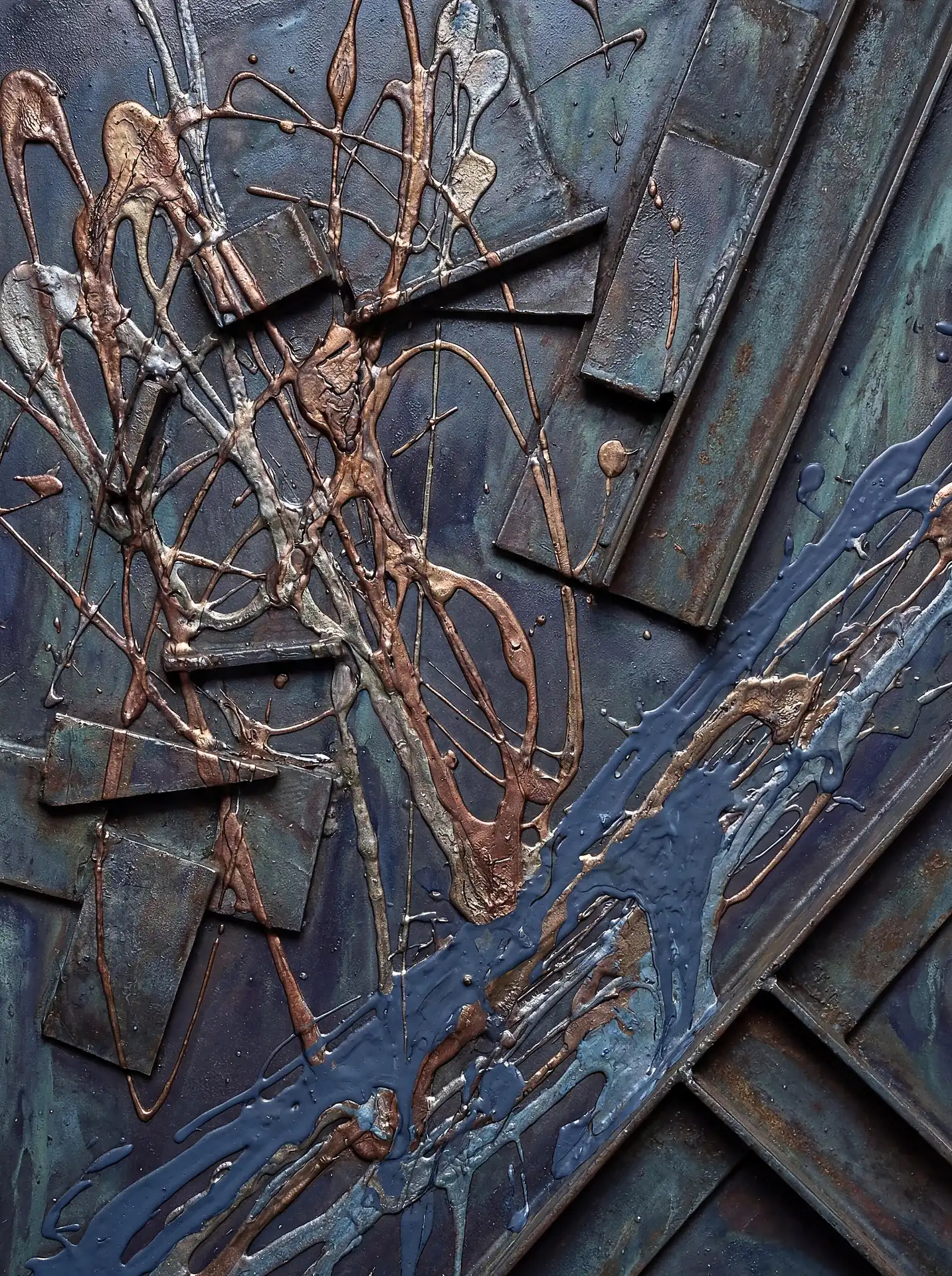 Spattering across heavy iron beams, metallic copper and blue pigments create a dynamic industrial relief sculpture. This abstract mixed media piece features deep textures, rusted metal surfaces, and a cold, urban color palette of teal, silver, and bronze. Artwork by Constantine Cheshire